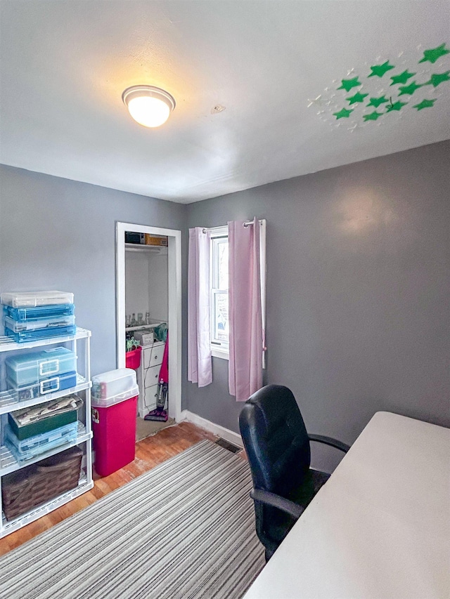 office area featuring wood finished floors and baseboards