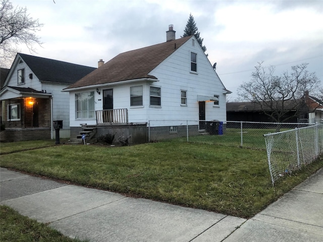 view of front of property with a front yard, fence, and a chimney