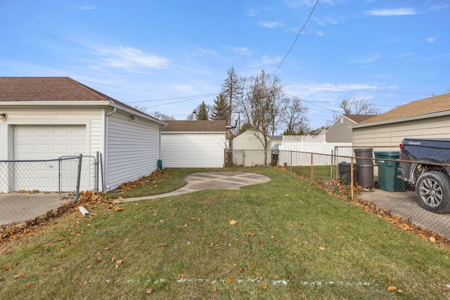 view of yard featuring a garage and fence