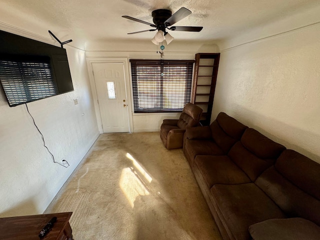 carpeted living room with a textured ceiling, a textured wall, and ceiling fan