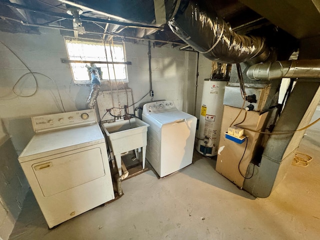 laundry room featuring laundry area, heating unit, washer and dryer, water heater, and a sink