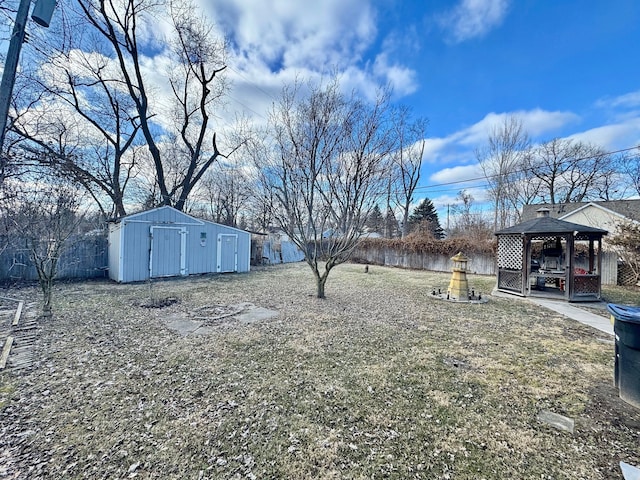 view of yard with an outdoor structure, a gazebo, and a shed