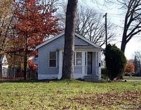 bungalow-style home featuring a front yard