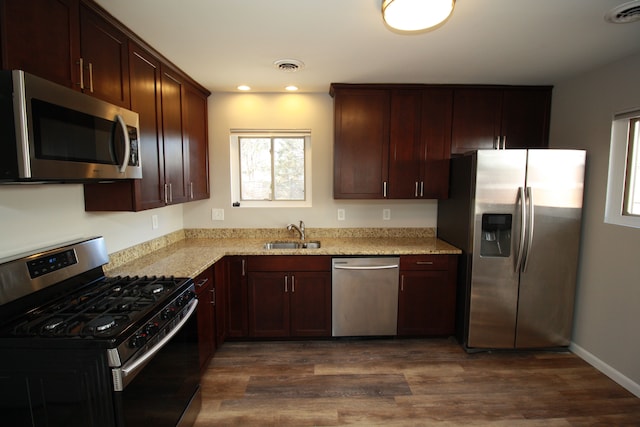 kitchen featuring visible vents, appliances with stainless steel finishes, dark wood-style flooring, and a sink