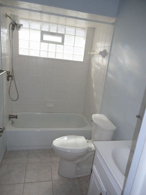 full bathroom featuring shower / washtub combination, tile patterned flooring, vanity, and toilet