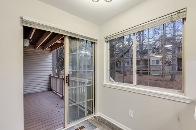 interior space featuring baseboards and wood finished floors