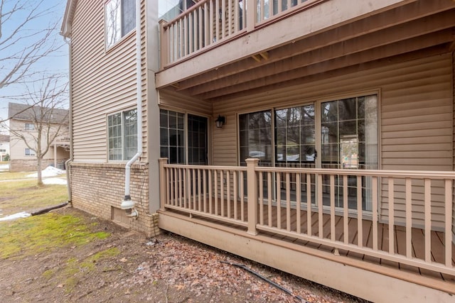 view of side of home with brick siding and a balcony