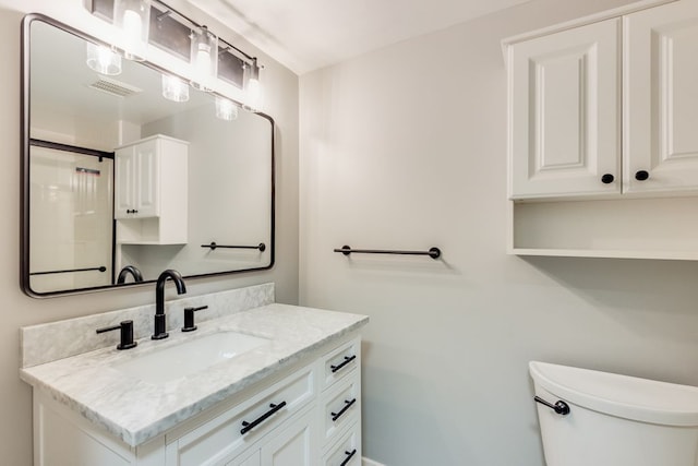 bathroom featuring visible vents, vanity, and toilet