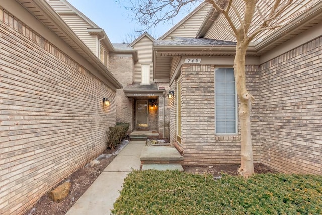 property entrance featuring brick siding