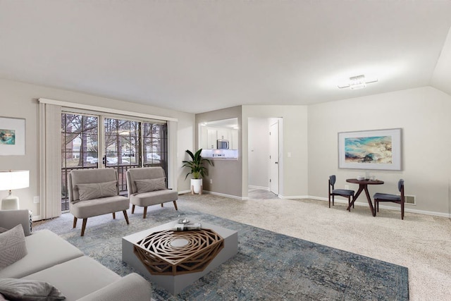 living room with lofted ceiling, baseboards, and carpet floors