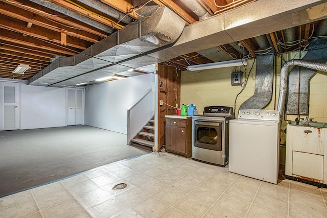 unfinished below grade area with stairway and washer and clothes dryer