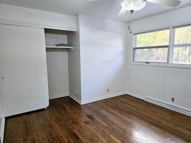 unfurnished bedroom with baseboards, a ceiling fan, a baseboard radiator, wood finished floors, and a closet