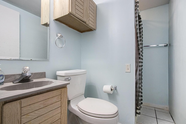 bathroom with vanity, toilet, and tile patterned floors