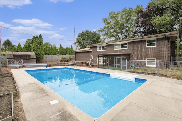 view of swimming pool with a fenced backyard, a patio, a fenced in pool, and an outdoor structure