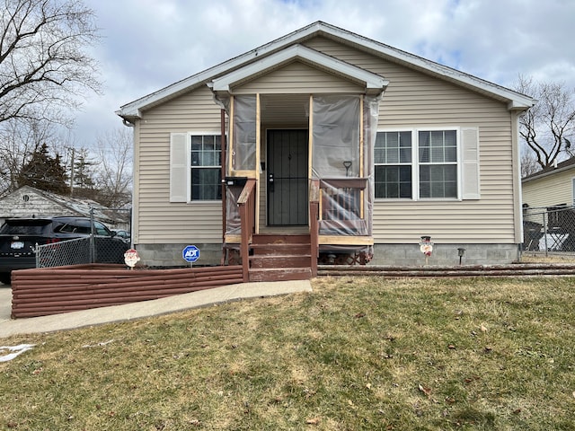 bungalow-style house with entry steps, fence, and a front yard