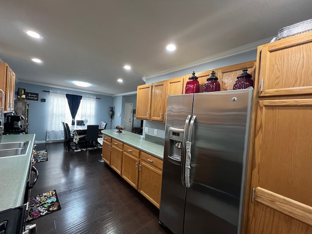 kitchen featuring stainless steel fridge, ornamental molding, dark wood-style flooring, light countertops, and recessed lighting