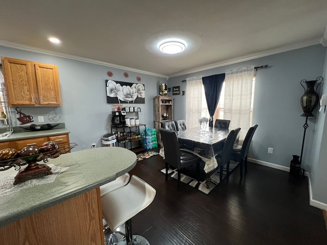 dining room featuring baseboards, dark wood finished floors, and crown molding