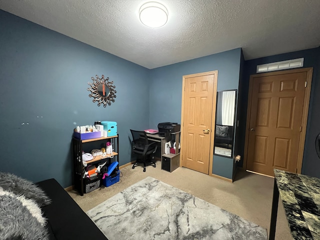 office area with carpet and a textured ceiling