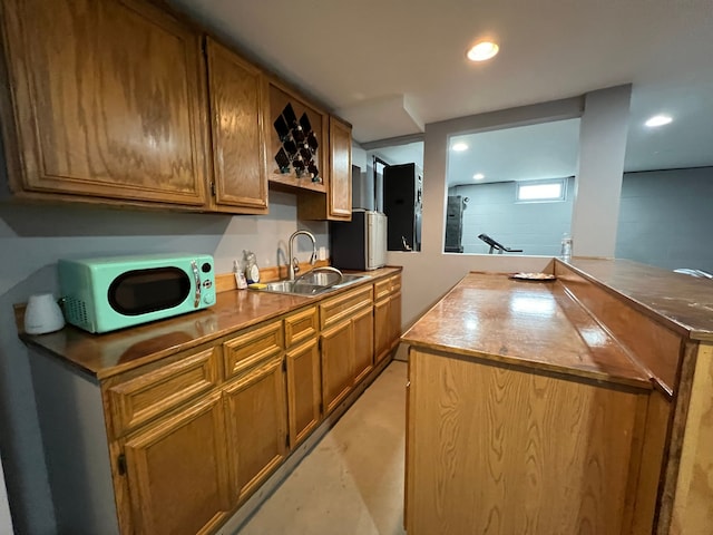 bar featuring refrigerator, a sink, and recessed lighting