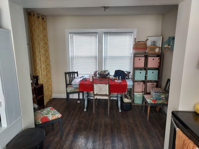 dining space featuring baseboards and wood finished floors