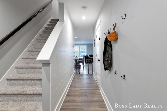 interior space featuring stairway, baseboards, wood finished floors, and recessed lighting