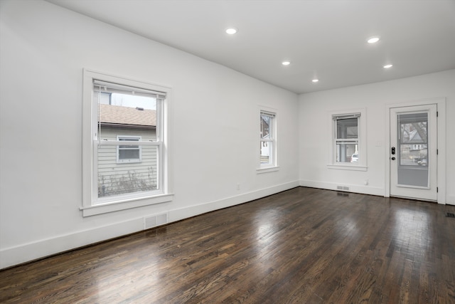 spare room with recessed lighting, visible vents, baseboards, and wood finished floors