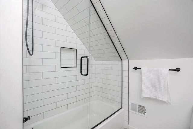 full bath with lofted ceiling, enclosed tub / shower combo, and visible vents