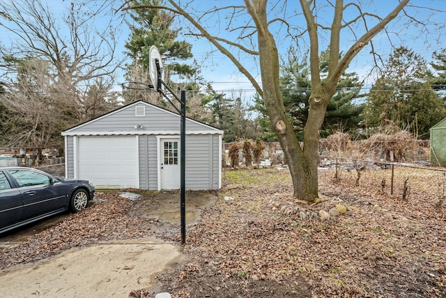 view of yard featuring an outbuilding, fence, and a garage