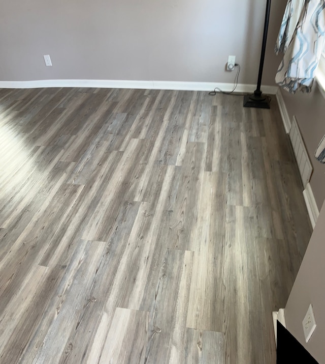 room details with visible vents, baseboards, and wood finished floors