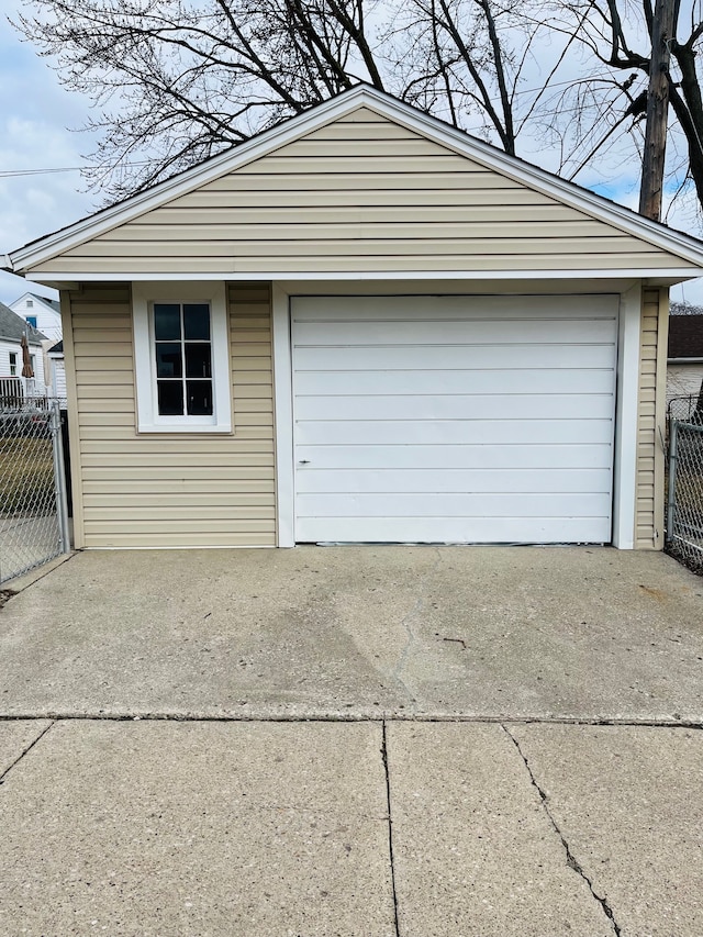 detached garage featuring fence