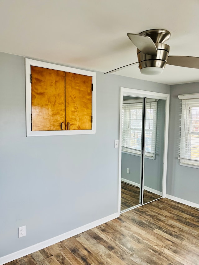 interior space featuring baseboards and wood finished floors