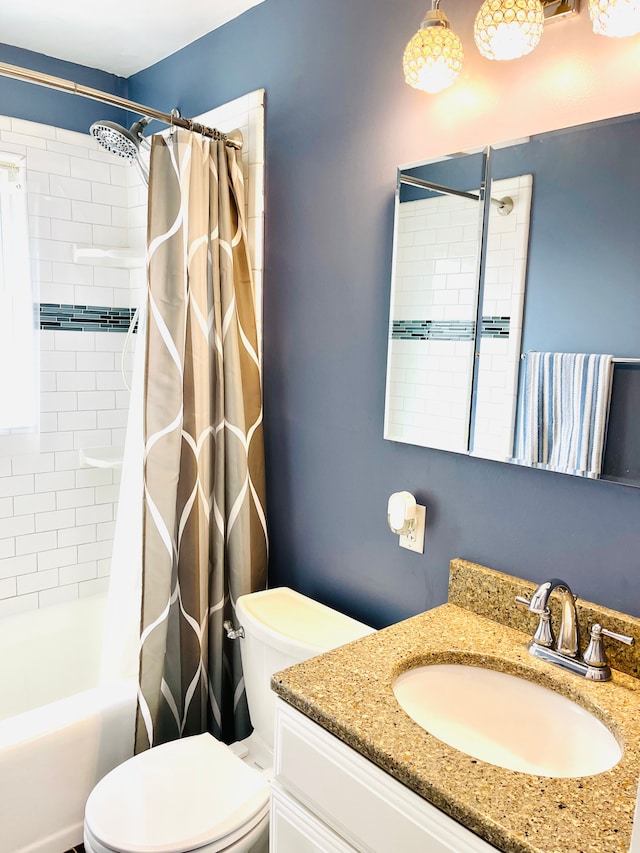 bathroom featuring shower / bath combo, vanity, and toilet