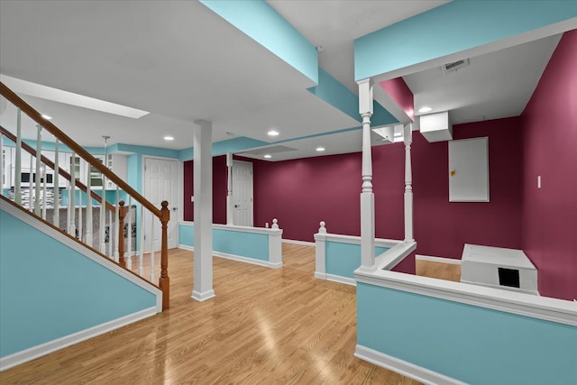 interior space with recessed lighting, wood finished floors, visible vents, baseboards, and stairway