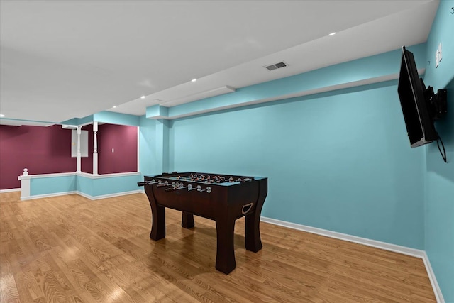 game room with wood finished floors, visible vents, and baseboards