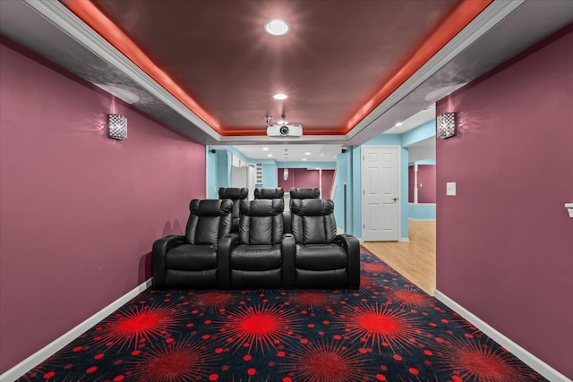 home theater featuring baseboards, a tray ceiling, and recessed lighting