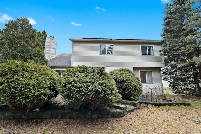 view of property exterior with a chimney