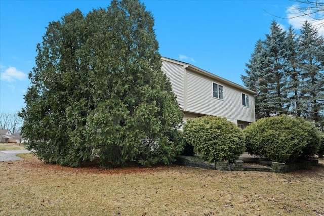 view of property exterior featuring a lawn