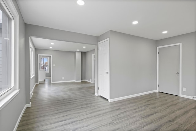 unfurnished room featuring recessed lighting, baseboards, and wood finished floors