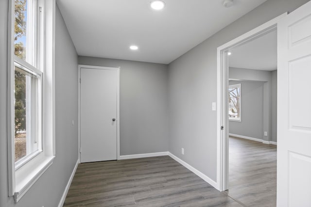 unfurnished room with recessed lighting, baseboards, and wood finished floors