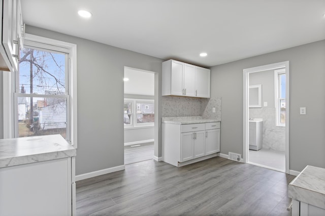 kitchen featuring white cabinetry, visible vents, light countertops, and wood finished floors