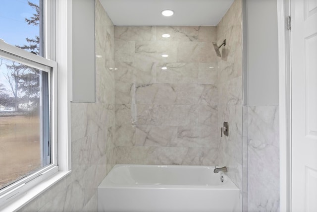 bathroom with bathtub / shower combination and a healthy amount of sunlight