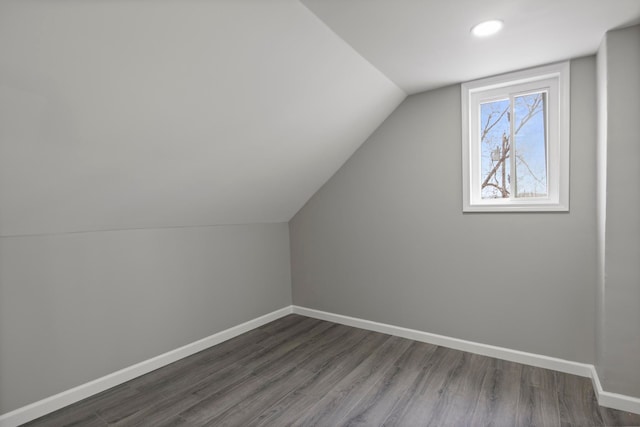 bonus room with vaulted ceiling, baseboards, and dark wood finished floors