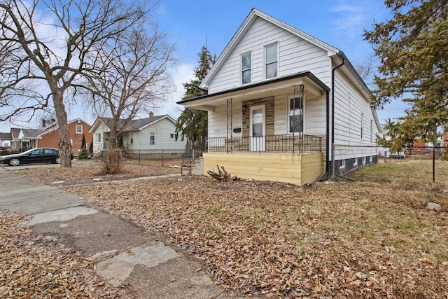 view of front facade featuring fence and a porch