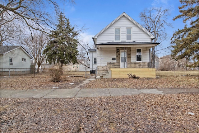 view of front of property with covered porch and a fenced front yard