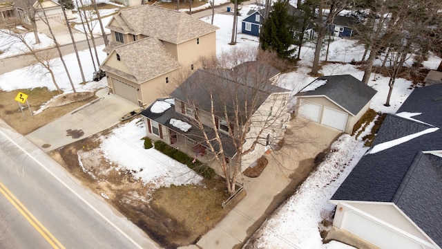 snowy aerial view featuring a residential view