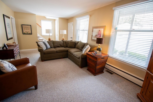 living area featuring visible vents, stairway, a baseboard heating unit, carpet flooring, and baseboards