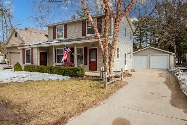 traditional-style house featuring covered porch, a detached garage, and an outdoor structure