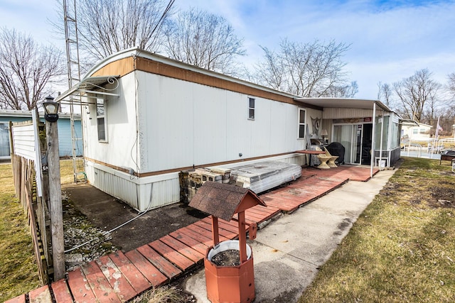 view of home's exterior featuring fence and a deck