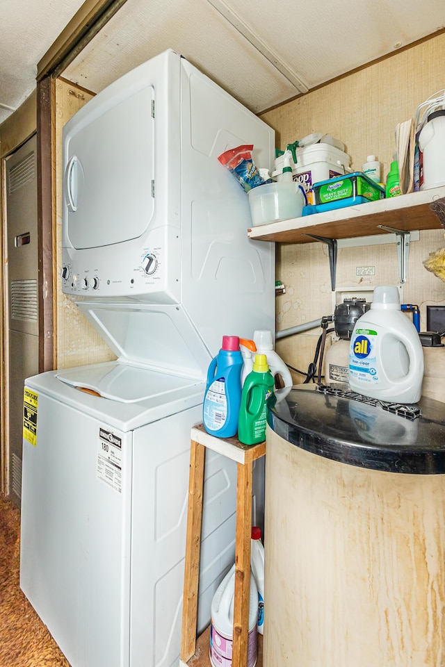 clothes washing area featuring laundry area and stacked washing maching and dryer