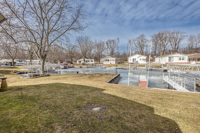 view of yard with a residential view and a boat dock